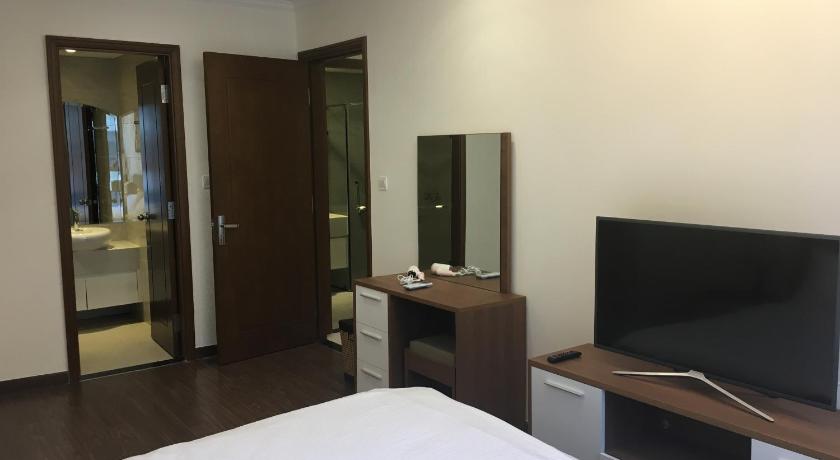 a hotel room with a bed and a television, Capitalland's Service Apartment Landmark Plus Vinhomes in Ho Chi Minh City