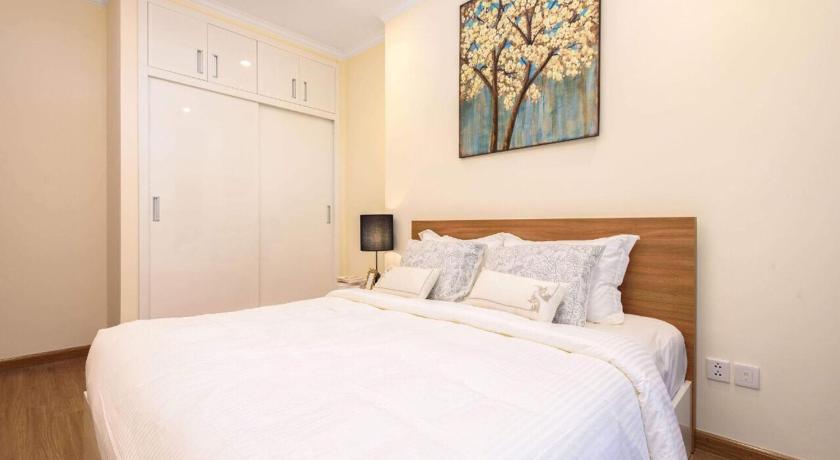 a bedroom with a white bed and white walls, Capitalland's Service Apartment Landmark Plus Vinhomes in Ho Chi Minh City