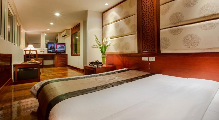 a bedroom with a large bed and a large window, Conifer Boutique Hotel in Hanoi