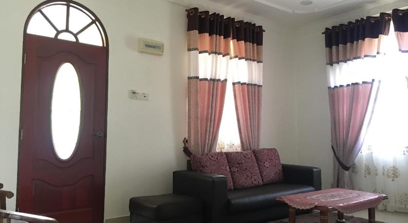 a living room filled with furniture and a large window, CM HOMESTAY in Kampung Raja (Terengganu)