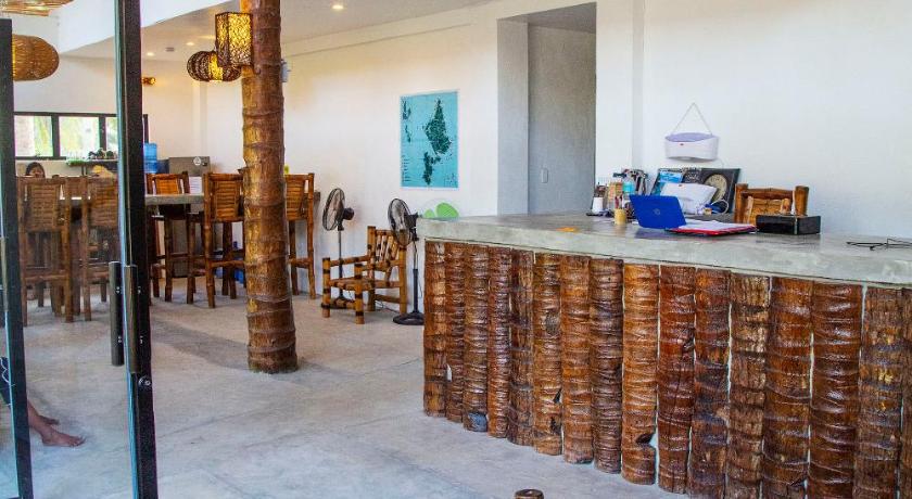 a living room filled with furniture and a patio area, Sunlit Hostel in Siargao Island