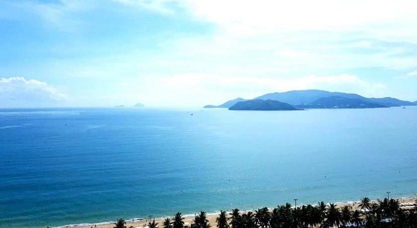 a beach with a view of the ocean, DTX Hotel Nha Trang in Nha Trang