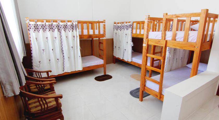 two bunk beds are in a room with wooden floors, Silas Garden in Yogyakarta