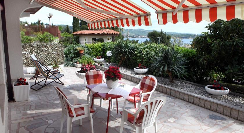 a patio area with tables, chairs and umbrellas, Lovely Sea View Apartments BJ in Portoroz