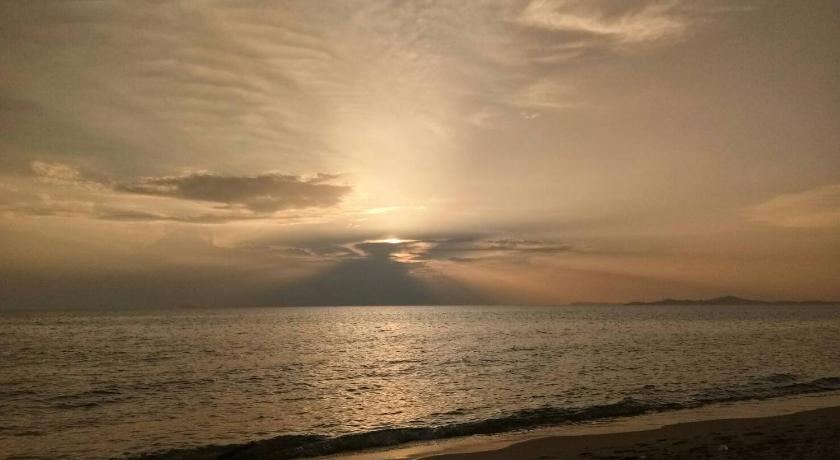 the sun is setting on the beach near the ocean, Ana Anan Resort & Villas Pattaya (SHA Extra Plus) in Pattaya