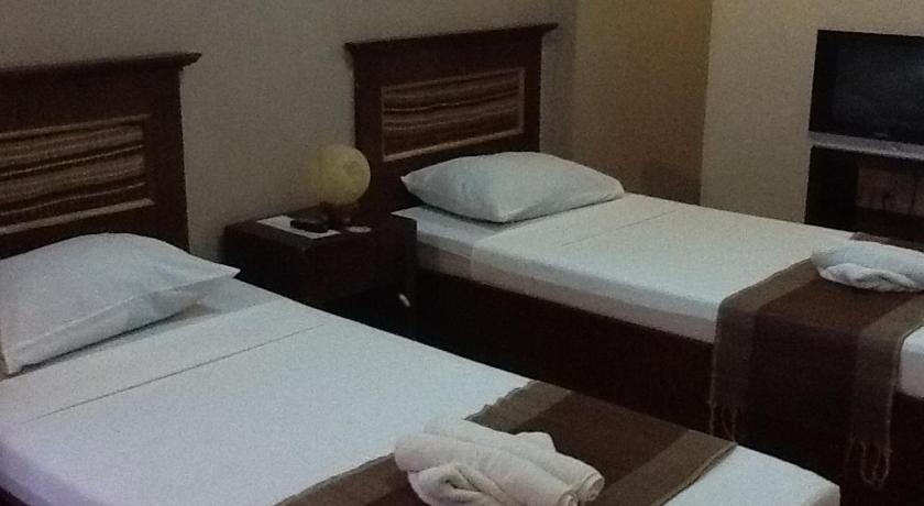 a hotel room with two beds and two nightstands, Darunday Manor in Bohol
