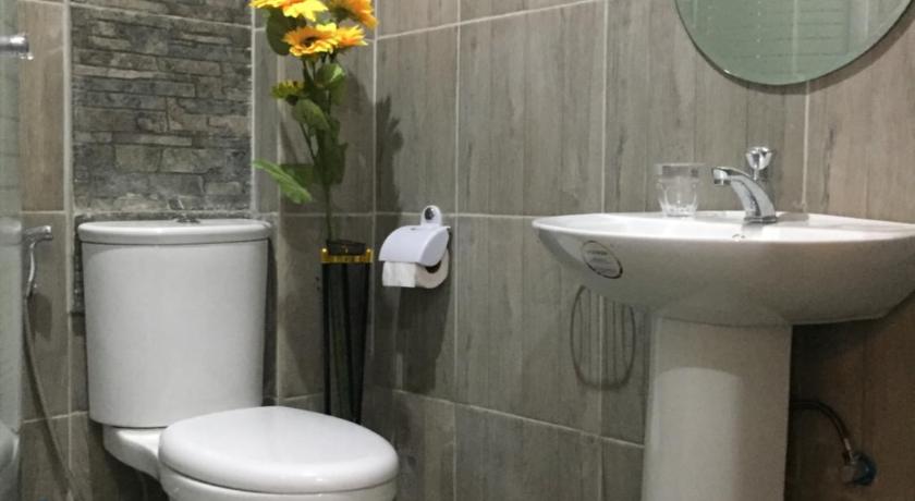 a white toilet sitting in a bathroom next to a sink, Mirasol Residences in Daet