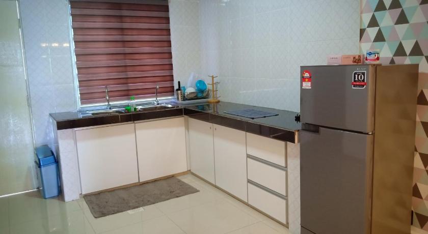 a kitchen with a refrigerator and a sink, AZURE SKY HOMESTAY KUALA SELANGOR in Kuala Selangor