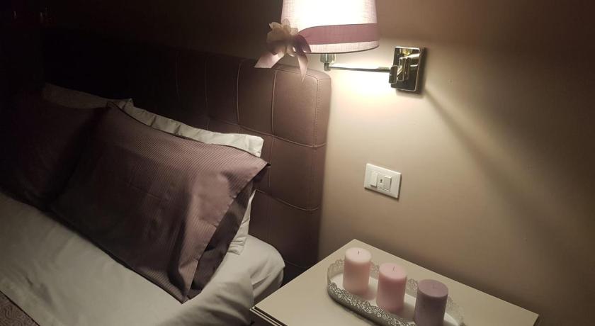 a bed with a lamp next to it, La Dimora del Falconiere - Luxury Suites in Sulmona