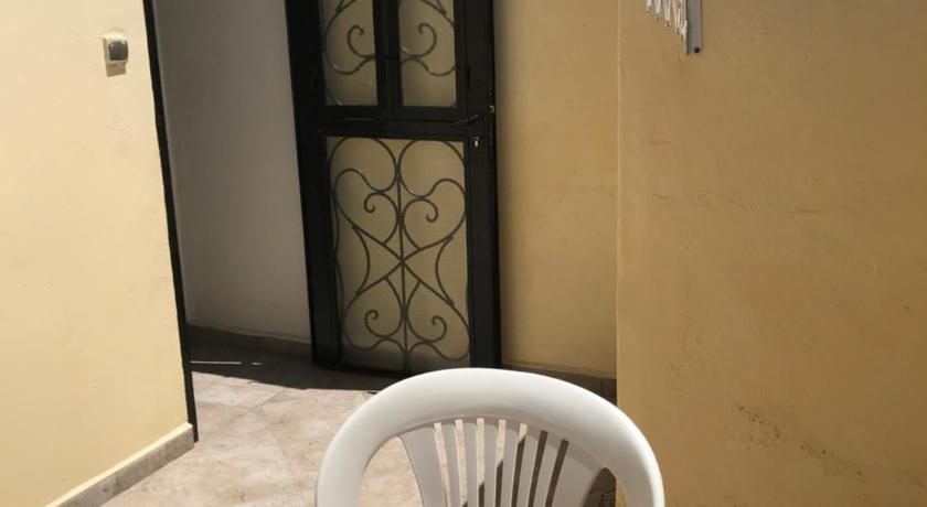 a chair and a table in a room, Ali Appartement in Essaouira