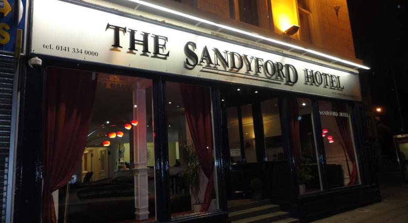 a restaurant with a neon sign on the side of the building, The Sandyford Hotel in Glasgow