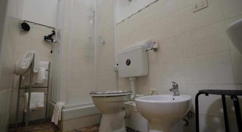 a bathroom with a toilet and a sink, Check-Inn Rooms Genova Centro in Genoa