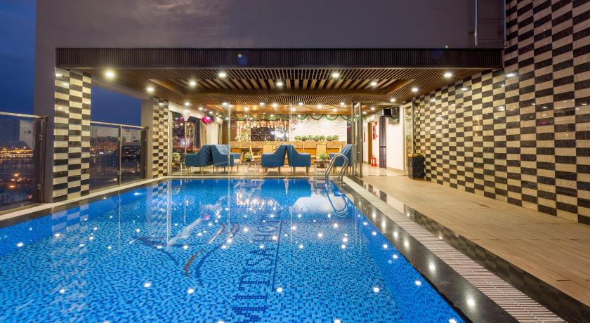 a swimming pool filled with lots of blue water, Mitisa Hotel Danang in Da Nang