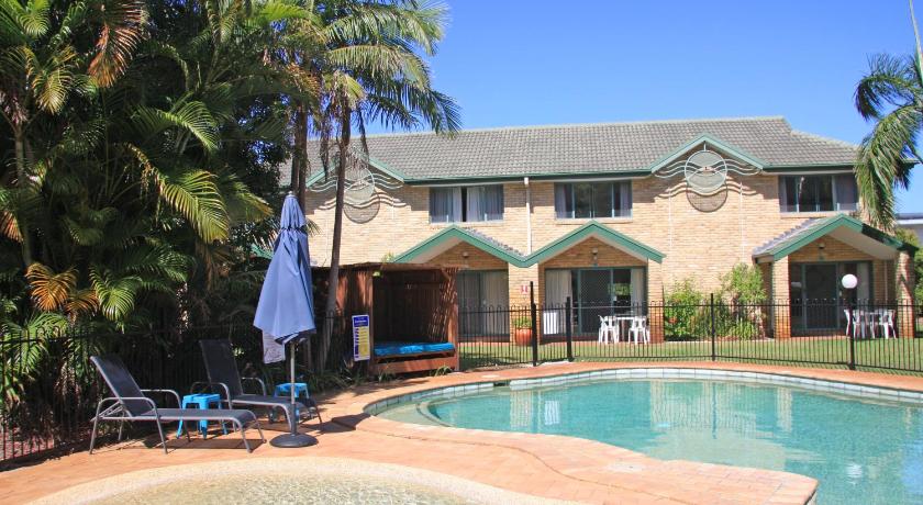 a house that has a pool and a lawn chair in front of it, Aqua Villa Resort in Coffs Harbour