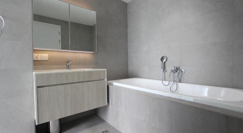 a bathroom with a tub, sink and mirror, 85 Soho Premium Serviced Residence in Yangon