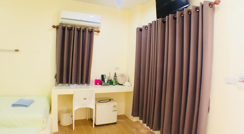 a room with a white curtain and a white toilet, Haadsaikaew Bankrut Resort in Prachuap Khiri Khan