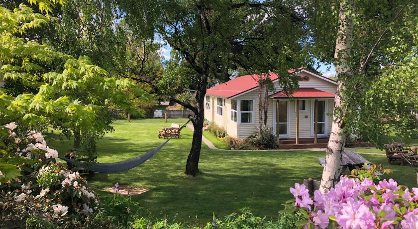 a house that has a tree in the yard, Tailor Made Tekapo Accommodation - Guesthouse & Hostel in Lake Tekapo