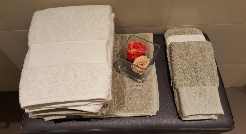 a stack of paper towels sitting on top of a bed, Assia & Nathalie - Luxury B&B MARAIS in Paris