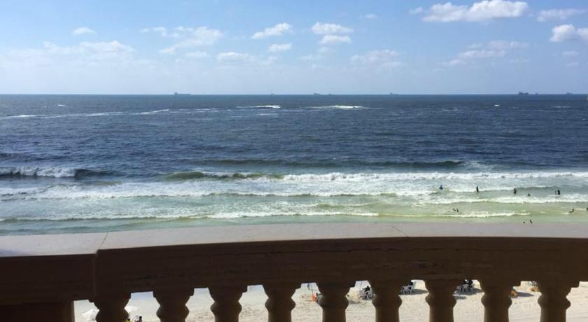 a view from the balcony of a beach with a view of the ocean, Agami Apartment in Alexandria