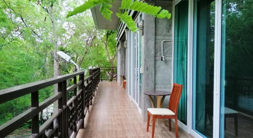 a wooden bench sitting in front of a walkway, Loei Huen Hao Hug Home & Resort in Loei
