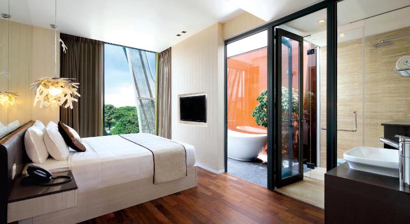 a hotel room with a large bed and a large window, ST Residences Novena in Singapore