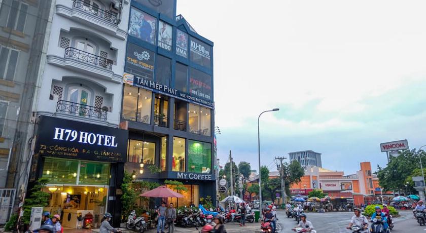 motorcycles are parked in front of a building, H79 Hotel in Ho Chi Minh City