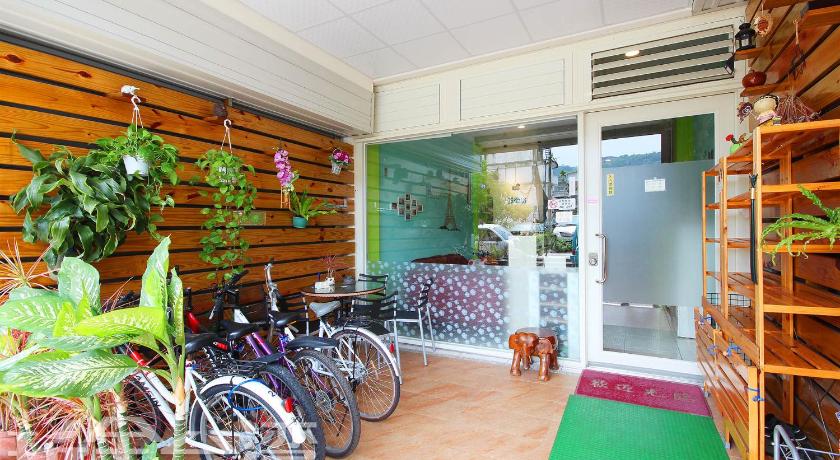 bicycles are parked in front of a large window, 25 Street B&B in Nantou