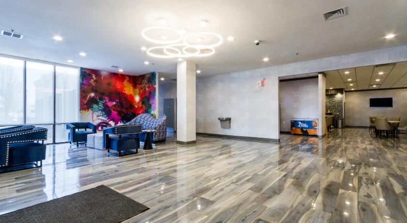 a room with a lot of furniture and a large stairwell, Best Western Plus Executive Residency Denver - Central Park Hotel in Denver (CO)