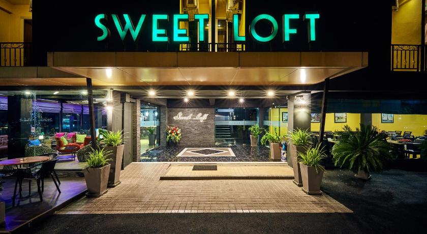 a neon sign on the side of a building, Sweetloft Hotel Don Muang in Bangkok