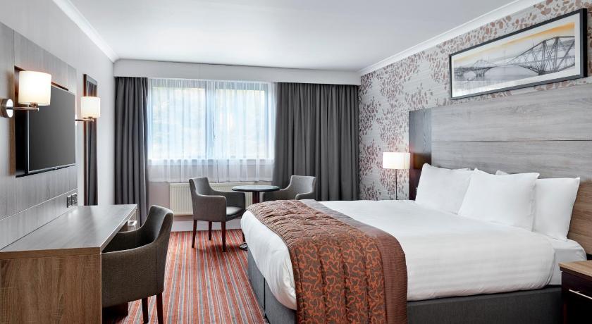 a hotel room with two beds and a television, Leonardo Hotel Edinburgh Murrayfield in Edinburgh