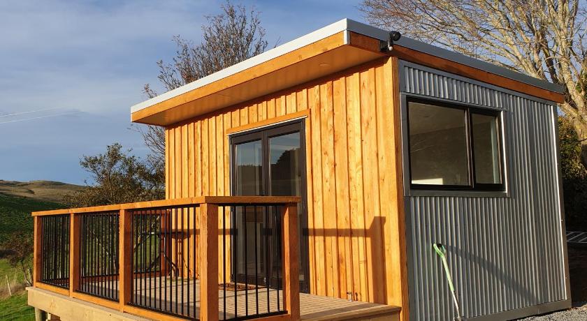a small wooden cabin with a wooden roof, Lawfield in Ahuriri Flat