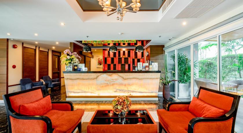 a living room filled with furniture and a large window, 247 Boutique Hotel in Pattaya
