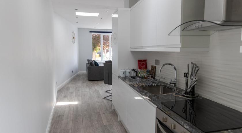 a kitchen with a sink and a stove, London Northwick Park Serviced Apartments by Riis Property in London