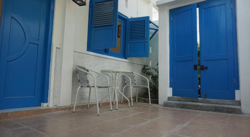 a room with a blue door and a blue bench, Wayang BnB in Yogyakarta