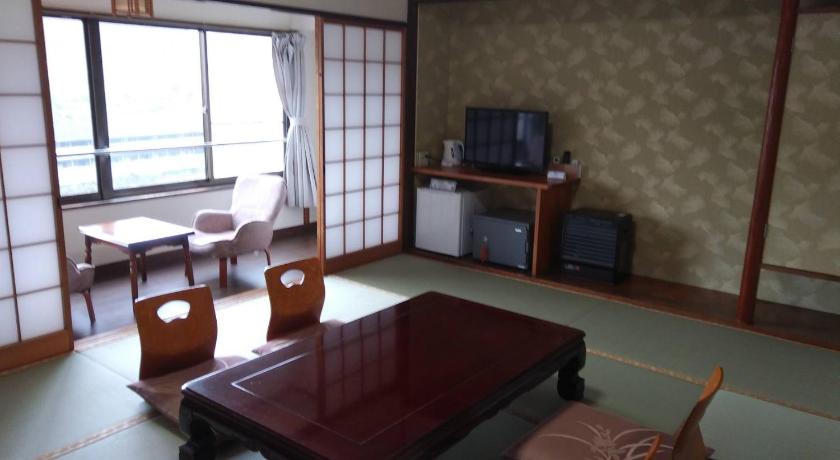 a living room filled with furniture and a window, Oyado Matsubaya in Minakami