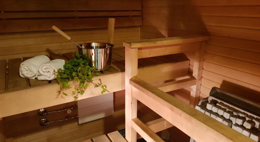 a wooden table topped with a wooden table cloth, 2ndhomes Deluxe Kamppi Center Apartment with Sauna in Helsinki