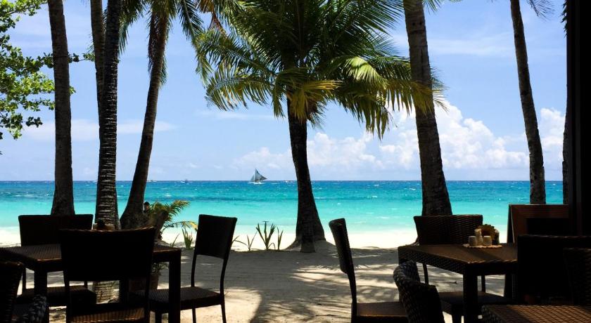 a beach area with tables, chairs and umbrellas, 357 Boracay Resort in Boracay Island