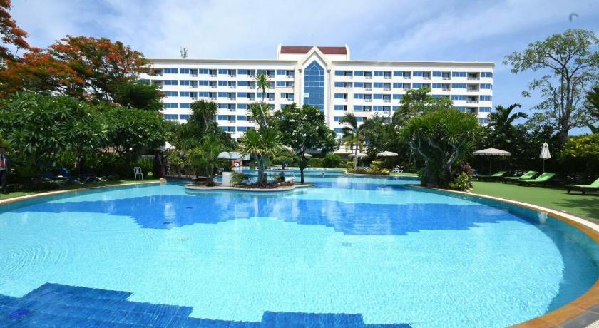 a large swimming pool in a large building, Jomtien Garden Hotel & Resort in Pattaya