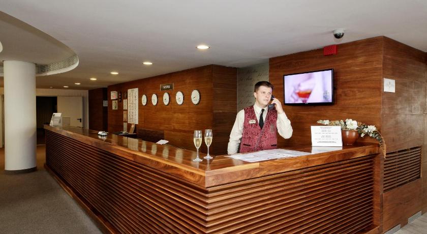 a man standing in front of a counter in a restaurant, Lighthouse Golf & Spa Hotel in Balchik