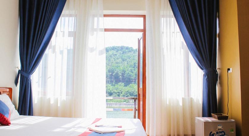 a hotel room with a bed and a window, Ahoj Guest House in Hạ Long