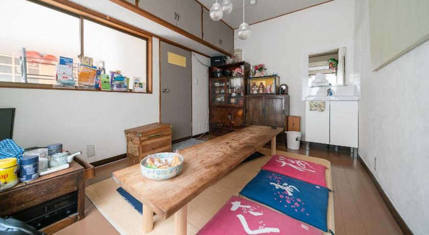 a living room filled with furniture and a coffee table, Ryokan Nakadaya in Tokyo