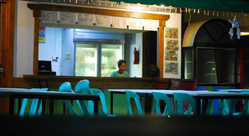 a person sitting at a table in a restaurant, 13 Ways Room Rentals in Bohol