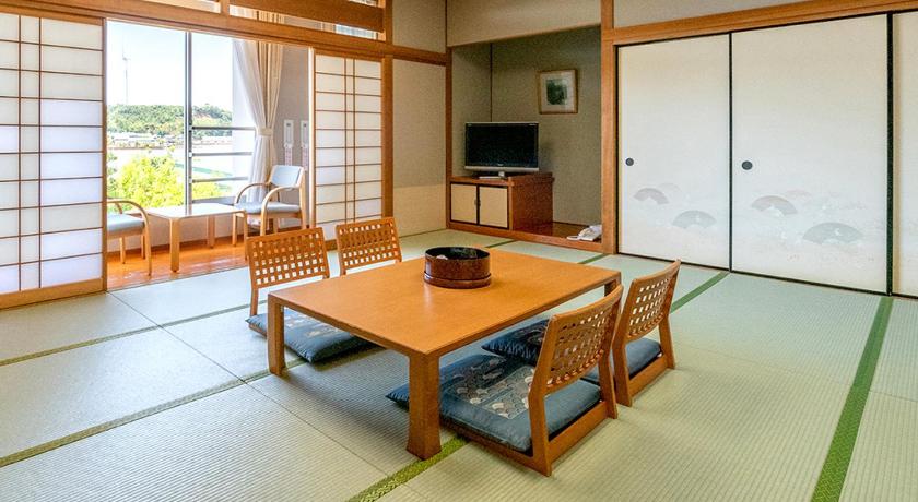 a living room with a table and chairs, Awarakitagata Onsen Kohanso Hanayurari in Awara