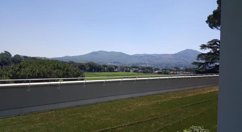 a view from a balcony of a grassy area, Villa Cavalletti Camere in Grottaferrata