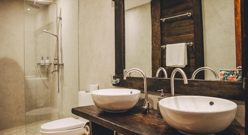 a bathroom with two sinks and a mirror, Hibiscus Garden Inn in Palawan