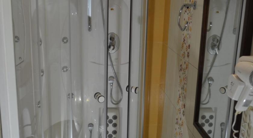 a bathroom with a shower, sink, and toilet, Agnanti Villas in Nafpaktos