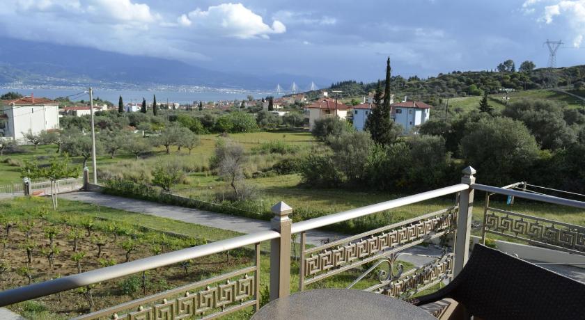 a large building with a view of a city, Agnanti Villas in Nafpaktos
