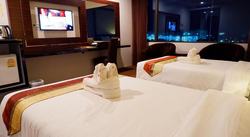 a hotel room with two beds and a television, Siam Oriental Hotel (SHA Plus+) in Hat Yai