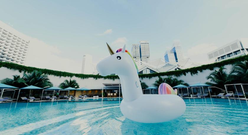 a swimming pool with a statue of a penguin in the middle of it, Pan Pacific Singapore (SG Clean Certified) in Singapore