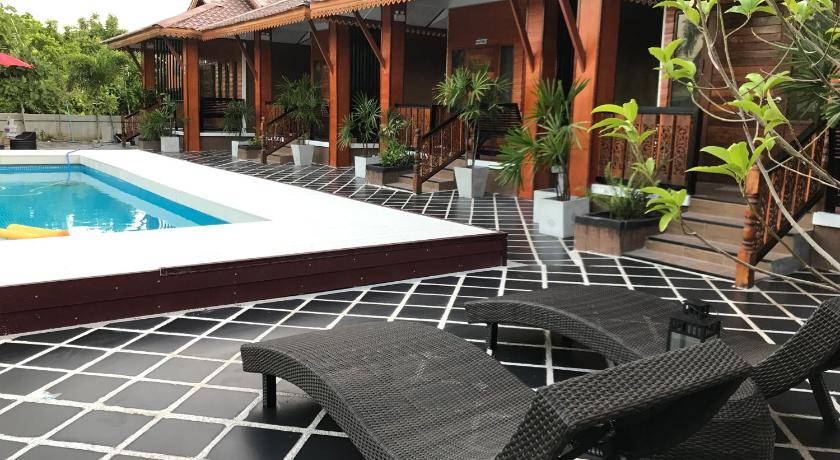 a patio area with chairs, tables, and a pool, Khum Lanna Boutique Hotel in Sisaket